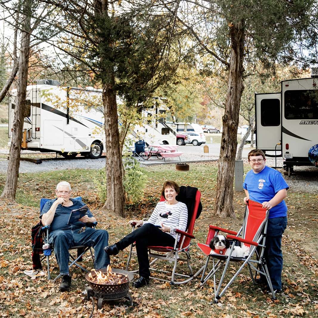 family enjoying private campfire at creekside rv park