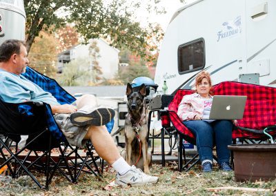 couple and dog at campsite