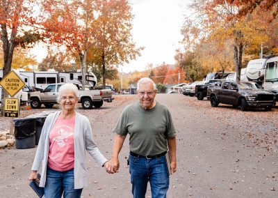 couple holding hands and walking at rv campsite