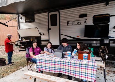 family enjoying campsite and grilling out