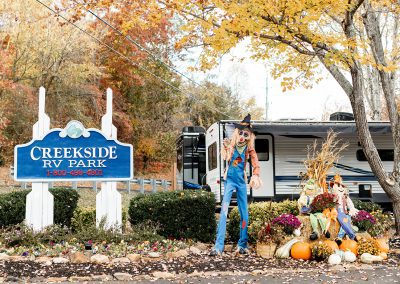 scarecrow and fall decorations at creekside rv park