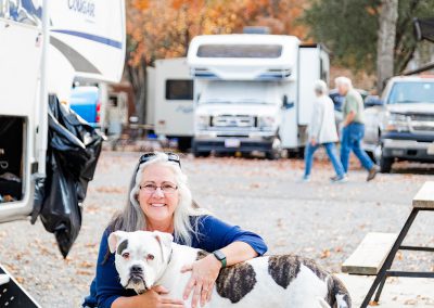 woman and dog at campsite